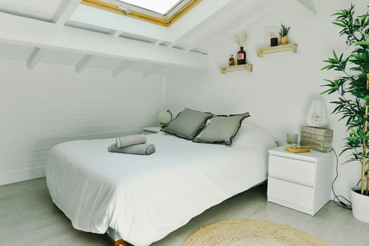 Chambre à l'étage avec lit double et linge de maison hôtelier